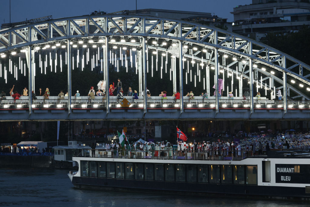 PARIS, FRANCE - JULY 26: Team Niger, Team Nigeria and Team Norway pass under a fashion show during the opening ceremony of the Olympic Games Paris 2024 on July 26, 2024 in Paris, France. (Photo by Alex Broadway/Getty Images)